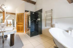 a bathroom with a shower and a tub and a sink at Hôtel Les Deux Chèvres Gevrey-Chambertin in Gevrey-Chambertin +50 photos