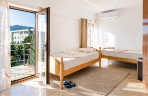 a bedroom with two beds and a balcony at Bar Hotel Tirana in Kukës