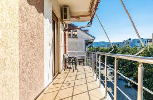 a balcony with a table and chairs on a building at Bar Hotel Tirana in Kukës