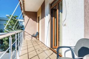 a balcony with chairs and an open door at Bar Hotel Tirana in Kukës