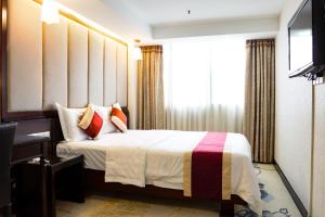 Letto o letti in una camera di New World Hotel