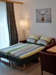 a bedroom with a bed with a deer on the wall at Ferienwohnung Schwarzwaldnest in Feldberg