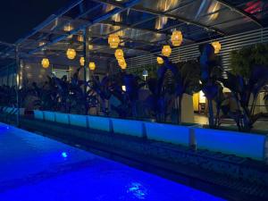 a swimming pool with blue lights and plants at Regenta Orkos Kolkata by Royal Orchid Hotels Limited in Kolkata
