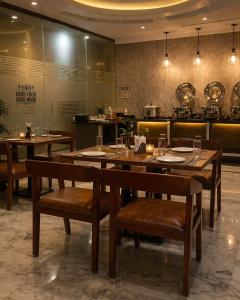 a restaurant with a table and chairs and a kitchen at IndiGo Line Hotel - Banjara Hills X Beside Paradise Biryani in Hyderabad