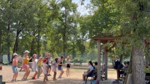 a group of girls playing a game in a park at Chalet privilège Parc de la Chesnaie in Autruy-sur-Juine