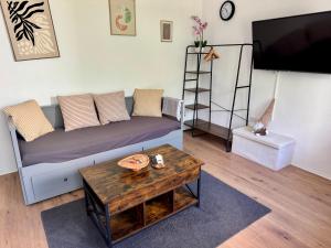 a living room with a couch and a coffee table at Mini Apartment mit Garten und Küche in Ilbenstadt
