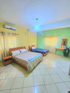 a bedroom with a bed and a table in it at Mimos Hotel in Tete