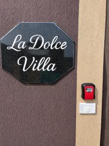 a sign that says la dolce vita on a wall at La Dolce Villa with Private Pool in Borg El Arab
