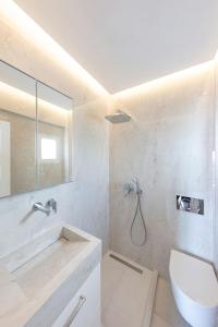 a bathroom with a shower and a toilet and a sink at Ibiscus down town location Myconos in Megali Ammos +62 photos