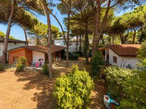 a view of a house and a yard with trees at Villa Pineta Grande in Lignano Sabbiadoro