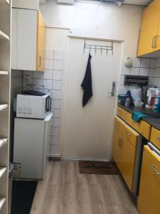 a kitchen with a white refrigerator and a microwave at Aangenaam & redelijk geprijsd in Amersfoort