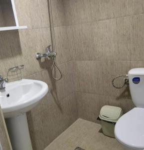 a bathroom with a shower and a toilet and a sink at SRC Bella Casa in Ohrid