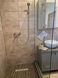 a bathroom with a shower and a sink at Porto Lima in Limanu +49 photos