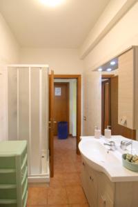 a bathroom with a sink and a shower with a mirror at Podere Cerretini in Montepulciano +20 photos