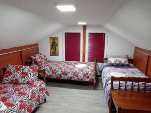 a room with two beds and a couch and a table at SRC Bella Casa in Ohrid