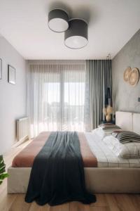 a bedroom with a large bed in front of a window at Das House in Kolhapur