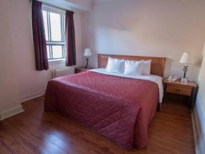 a bedroom with a large bed with a red blanket at Das House in Kolhapur