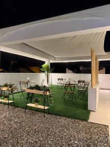 a group of tables and chairs in a room at Apartamentos Alsa in Conil de la Frontera