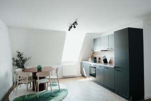 a kitchen with a table and a dining room at The Haus HANS Nuremberg in Nuremberg