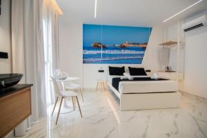 a white living room with a couch and a table at Apartamentos Alsa in Conil de la Frontera