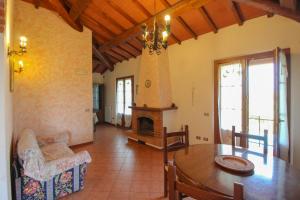 a living room with a table and a fireplace at Podere Cerretini in Montepulciano