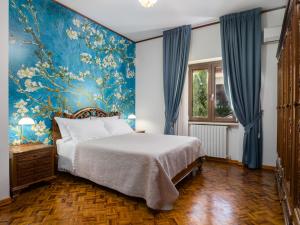 a bedroom with a large bed and a blue wall at Villa Francesca Luxury Rooms in San Demetrio Corone