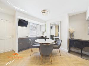 a dining room with a table and chairs at Cosy Colne Cottage in Colne +3 photos
