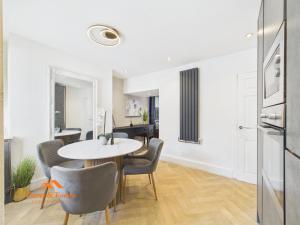 a dining room with a table and chairs at Cosy Colne Cottage in Colne