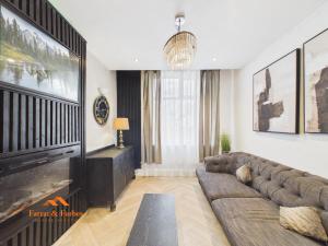 a living room with a couch and a fireplace at Cosy Colne Cottage in Colne