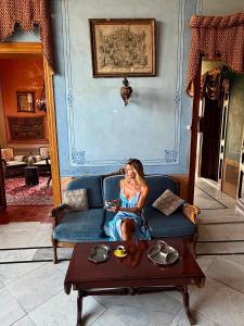 a woman sitting on a couch in a living room at Stone Cellars in Douma