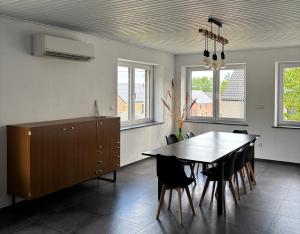 a dining room with a table and chairs at Le Gîte du Trieux - Berzée in Berzée