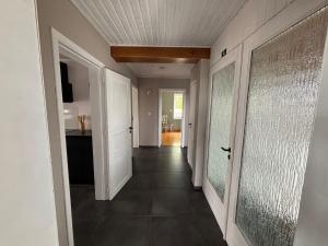 a hallway of a home with a door and a hallwayngth at Le Gîte du Trieux - Berzée in Berzée