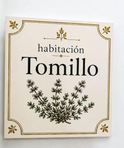 a sign for a hair salon with a flower wreath at Aromas del Raposo in Puebla de Sancho Pérez