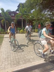 a group of people riding bikes down a street at Meegahapokuna Resort in Anuradhapura