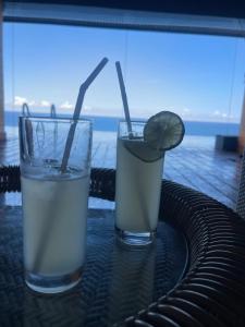 two glasses of water and a slice of lime on a table at Grand Hotel Villa Ella in Bandarawela