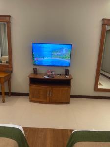 a living room with a flat screen tv on a wall at Grand Hotel Villa Ella in Bandarawela