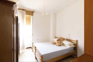 a bedroom with a bed with a teddy bear on it at la casa rossa in Suni