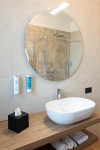 a bathroom with a white sink and a mirror at DB Residence Luxury Stay in Noventa di Piave +43 photos