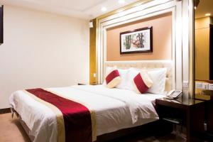 Letto o letti in una camera di New World Hotel