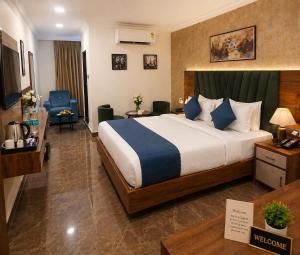 a hotel room with a large bed and a desk at IndiGo Line Hotel - Banjara Hills X Beside Paradise Biryani in Hyderabad +68 photos