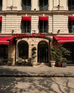 a building with adqabyitz sign on the front of it at Hôtel Derby Eiffel in Paris