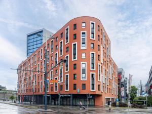 a large red brick building on a city street at smartments Wien Hauptbahnhof - Serviced Apartments in Vienna