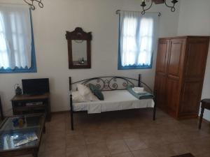 a bedroom with a bed with a mirror and a dresser at Meraki lipsi apartment in Leipsoi