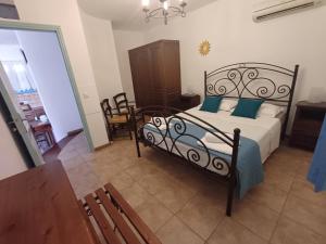 a bedroom with a bed with blue pillows at Meraki lipsi apartment in Leipsoi