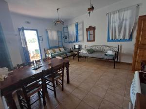 a living room with a table and a couch at Meraki lipsi apartment in Leipsoi +16 photos