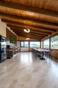 a large room with a table and chairs in it at Panoramic Hill Jina in Jina