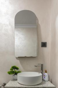 a bathroom with a large mirror and a sink at Panoramic Hill Jina in Jina +57 photos