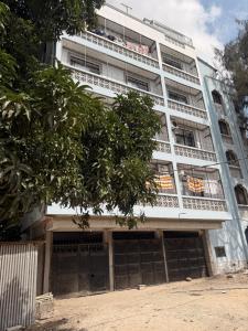 a large white building with a lot of windows at JnG HOMES in Malindi