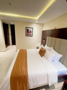 a large white bed in a hotel room at Lagos Airport Hotel in Ikeja