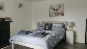 a bedroom with a bed with towels on it at The Smithy at 52 Vatisker in Stornoway